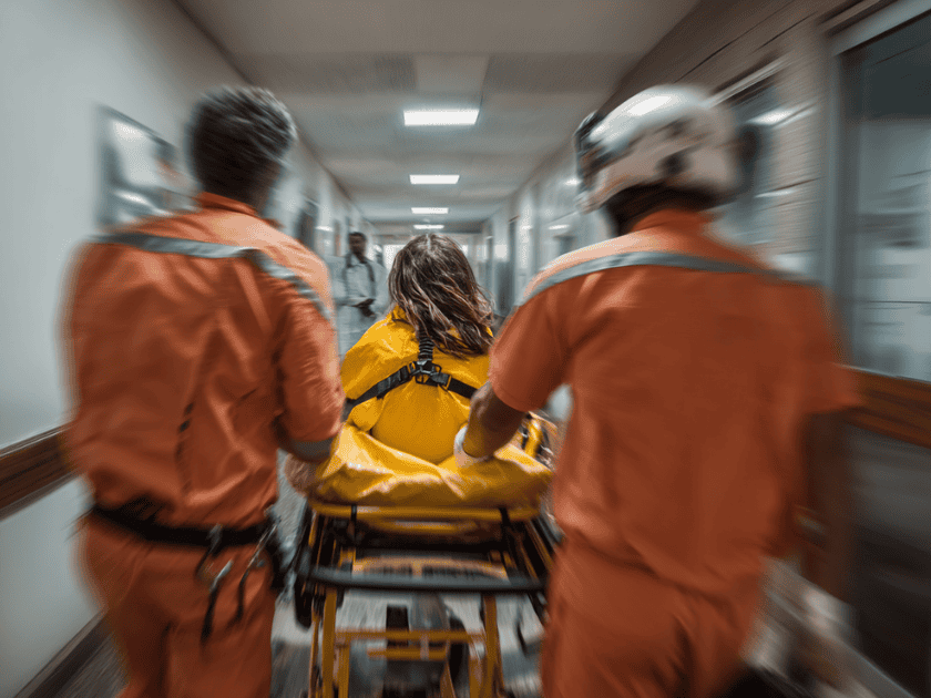woman in stretcher and paramedics taking her into emergency room