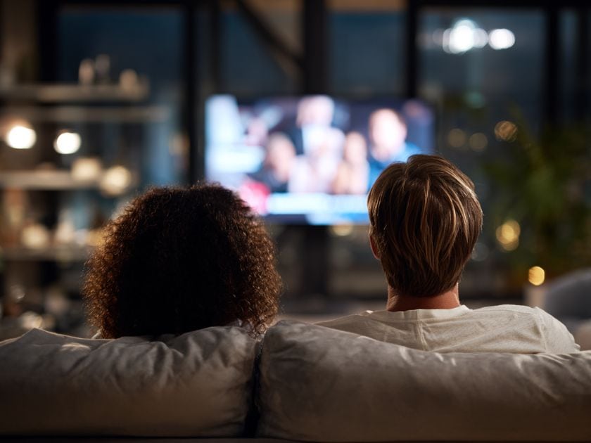 A couple watching the news on tv